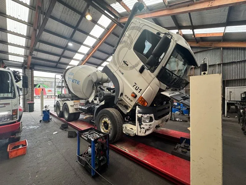 TDM mechanic with Fuso truck cab tilted