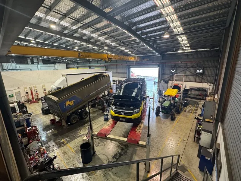 TDM mechanic servicing Green Gorilla waste truck