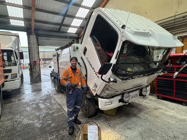 TDM mechanic working on truck engine